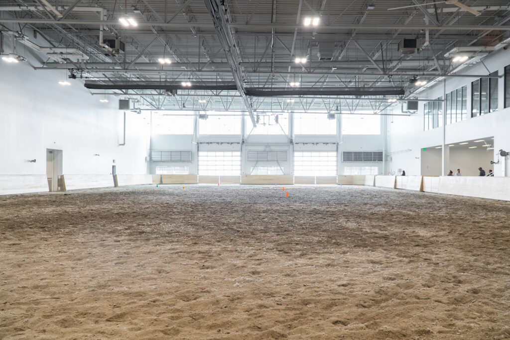Empty arena with a dirt floor.
