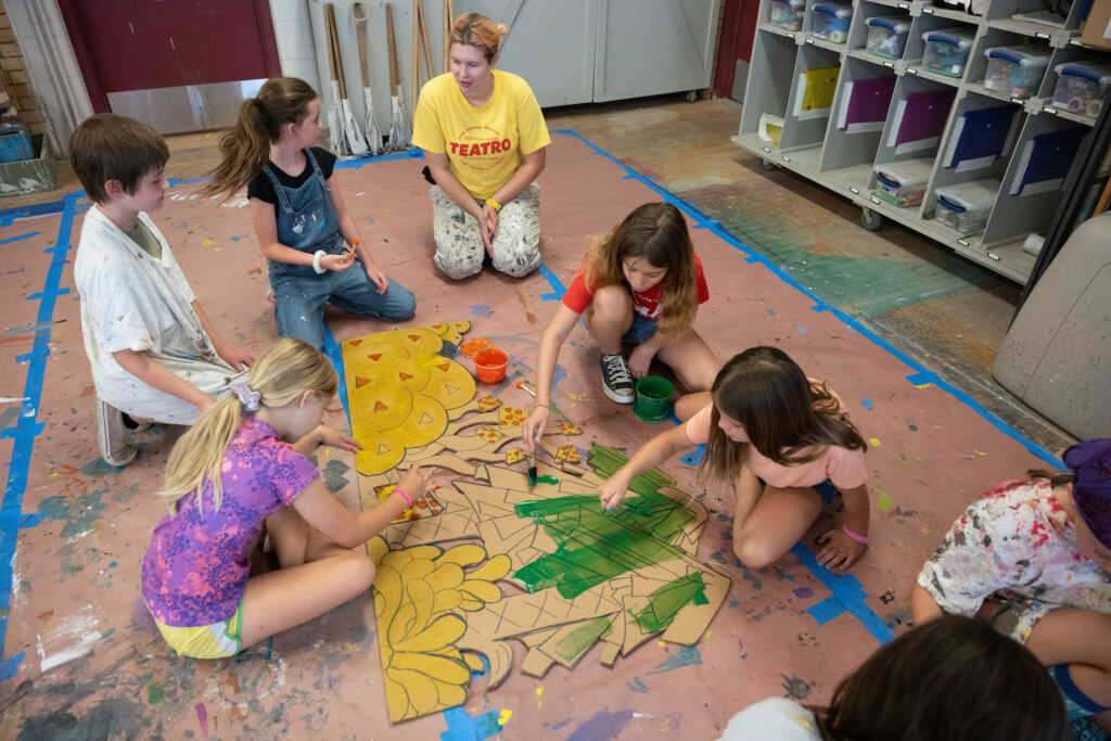 Kids work together on an art project.