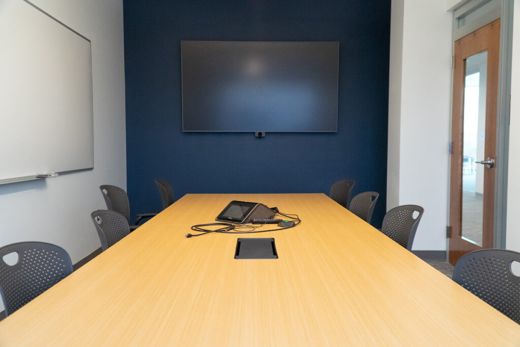 Conference room with a tv on the wall.