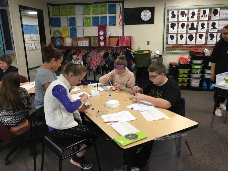 Students work together at a table.