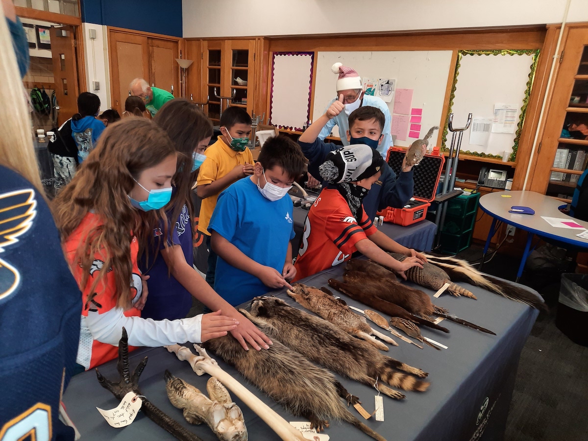 Students interact with various animal pelts.