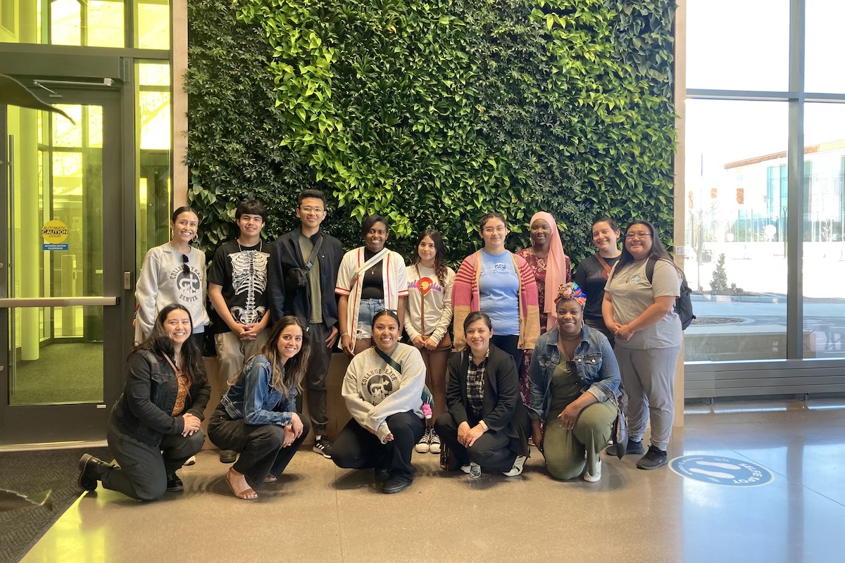 Group photo in front of a living wall.