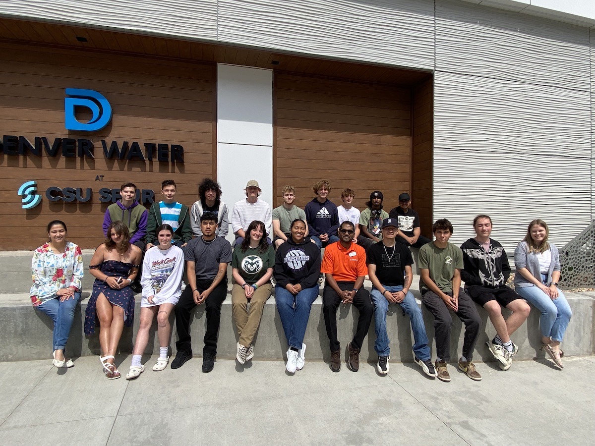 Group photo outside of a building with the Denver Water logo.