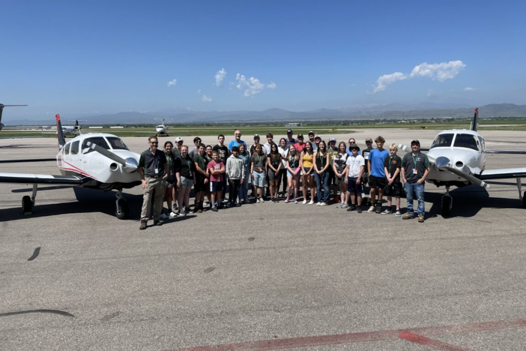 Group photo near an aircraft.