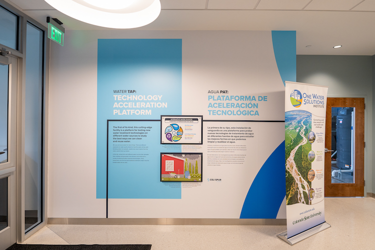 Wall-mounted panels showing information about the Water TAP lab.