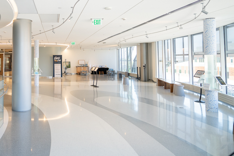Open space with columns that have a clear section holding water and information about water quality.