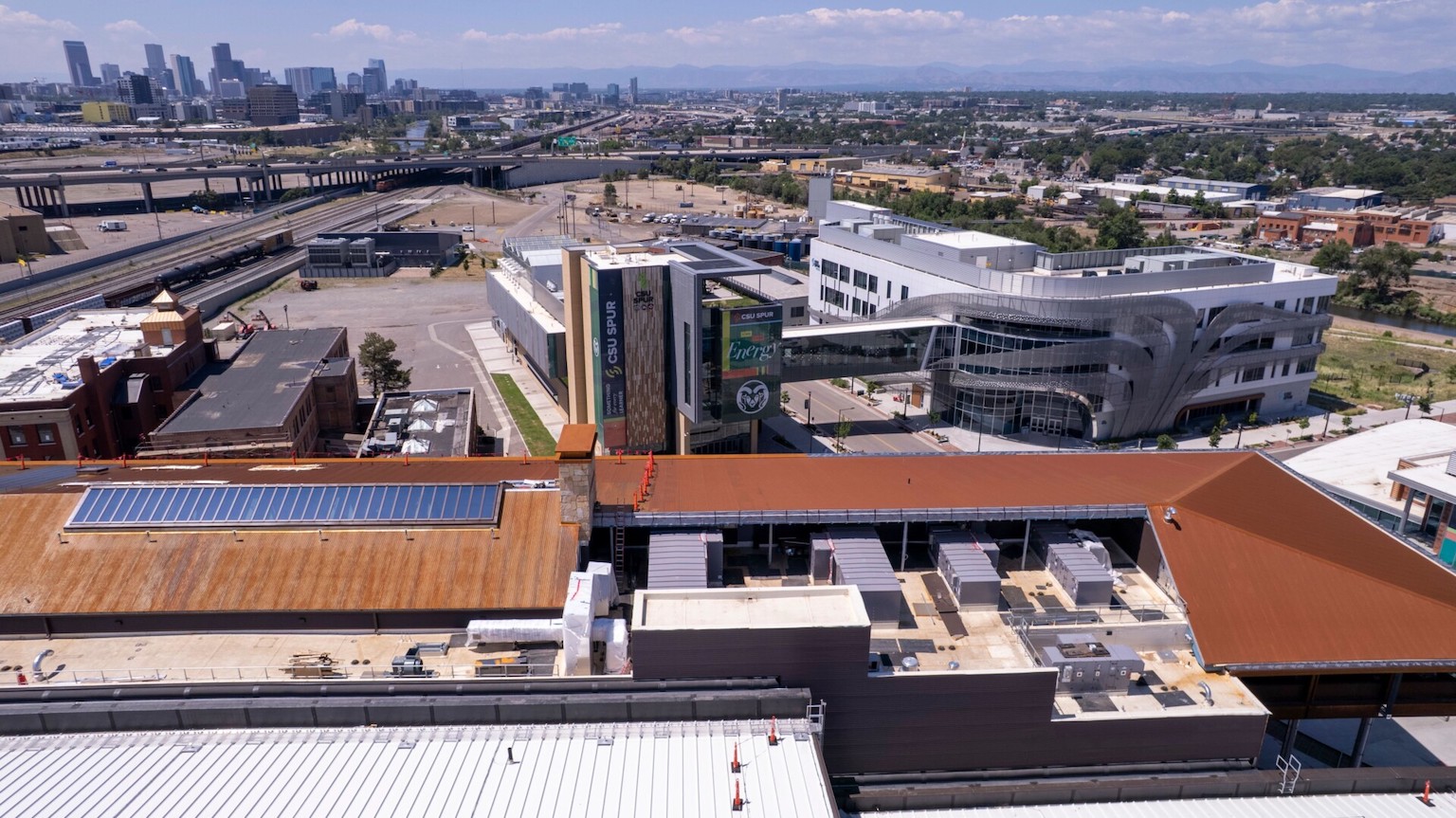 Aerial view of the CSU Spur campus with the Denver skyline in the background.